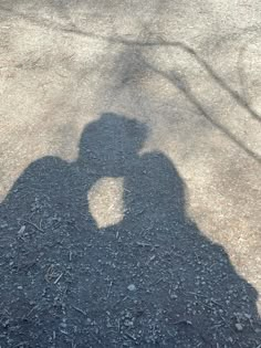 the shadow of a person holding a skateboard