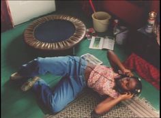 a woman laying on the floor next to a table