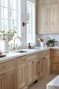 a kitchen filled with lots of wooden cabinets and white counter tops next to a window