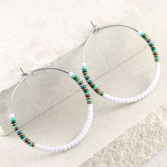 Seed bead hoop earrings in white and turquoise. * DETAILS:    ‣ Japanese glass seed beads     ‣ colors: matte white and turquoise + shiny, metallic green, bronze, red bronze and hematite    ‣ carefully handmade, polished earring hoops, made of 316L stainless steel * SIZE (choose from the drop-down menu):    ‣ SMALL:    approx Ø: 1.3" / 3.4 cm   ‣ LARGE:   approx Ø: 1.65" / 4.2 cm   size of the beads: 2 mm Very lightweight earrings, comfortable to wear. Click here for more beaded hoop earrings: w Bohemian White Hoop Earrings For Beach, White Dangle Hoop Earrings With Colorful Beads, White Dangling Hoop Earrings With Colorful Beads, Nickel Free White Circle Hoop Earrings, Adjustable White Hoop Earrings With Ear Wire, White Bohemian Dangle Hoop Earrings, Adjustable Nickel-free White Hoop Earrings, Adjustable White Nickel Free Hoop Earrings, Adjustable White Hoop Earrings With Colorful Beads