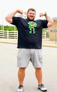 a man standing in the street flexing his muscles