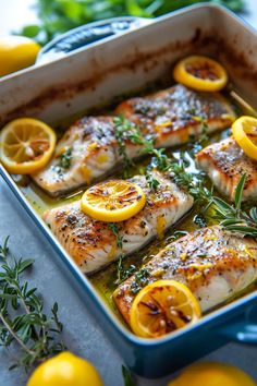 chicken with lemons and herbs in a baking dish