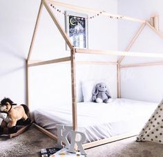 a child's bedroom with a bed and stuffed animals