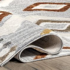 a close up of a rug on the floor with an area rug in the middle