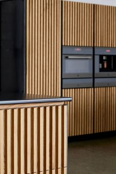 a kitchen with wooden cabinets and black appliances