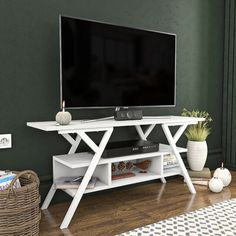 a flat screen tv sitting on top of a white entertainment center in a living room