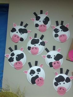 paper plates with farm animals on them are arranged in the shape of cow's heads