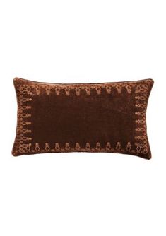 a brown pillow with an embroidered design on the front and back, sitting against a white background