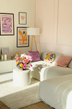 a living room filled with furniture and flowers on top of a white carpeted floor