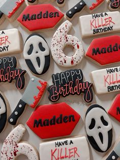 decorated cookies with happy birthday messages and decorations for the halloween themed party are displayed on a table