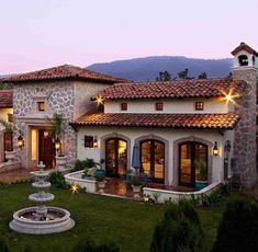 a house with a fountain in the front yard