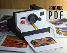 a printable polaroid printer sitting on top of pictures