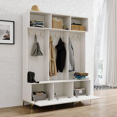 a white coat rack with several coats hanging on it