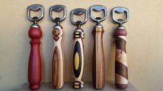 five different types of kitchen knives lined up in a row on a shelf with handles