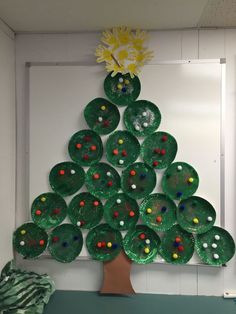 a paper plate christmas tree made from green plates