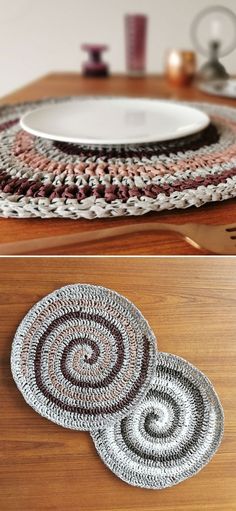 two crocheted placemats sitting on top of a wooden table next to a plate