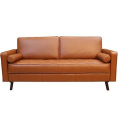 a brown leather couch sitting on top of a white floor