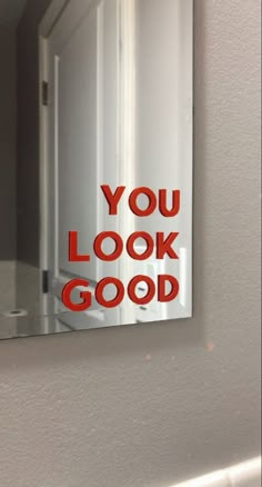 a mirror with the words you look good on it