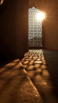 the sun shines brightly through an arch in a building's wall and floor