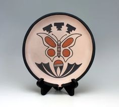 a small plate with an image of a butterfly on it's front and sides