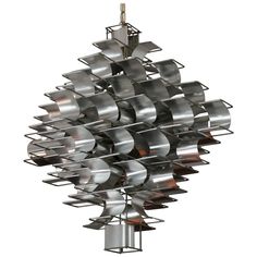 a large metal sculpture with many pots hanging from it's sides and two lights on each side