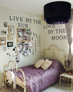 a bedroom with pictures on the wall and a purple bed in front of a window