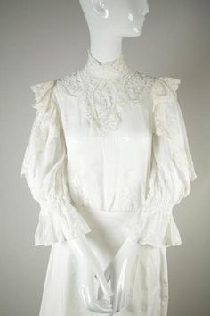 Pristine Edwardian cotton blouse with intricate lace and embroidery with a button closure at the back. Rare find with no discoloration. All the beautiful lace and embroidery are in tact. Shown with S065 Skirt. Near Mint Condition: No damages, as close to new as possible for age. Will fit size 4-6: Elegant Cotton Lace Top With Ruffles, Elegant Cotton Lace Top With Lace Collar, Elegant Cotton Lace Top, Elegant Cotton Lace Daywear Top, Elegant Cotton Lace Top With Lace Work, Cotton Victorian Dress For Formal Occasions, Feminine Lace Top With Lace Cuffs For Wedding, Long Sleeve Lace Top With Lace Collar For Wedding, Elegant Victorian Dress In Vintage White