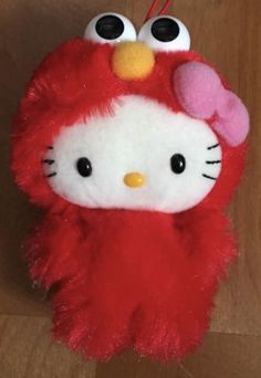 a hello kitty stuffed animal hanging on a wall