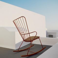 a rocking chair sitting on top of a roof