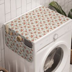 a white washer sitting next to a tiled wall