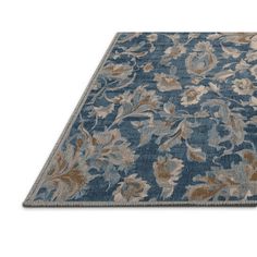 a blue and beige rug with flowers on it