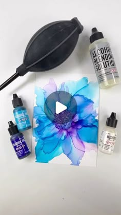 the supplies needed to make an acrylic flower painting on a white table top