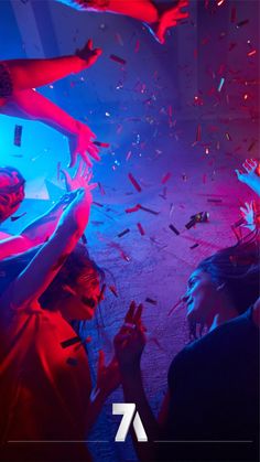 two people are dancing with confetti in front of them at a club or nightclub