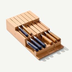 a set of knives in a wooden holder