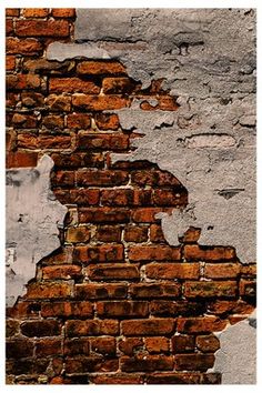 an old brick wall with peeling paint