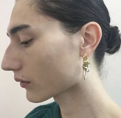 a close up of a person wearing some kind of earring on their left ear