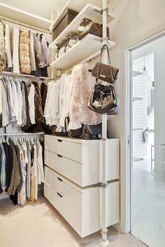 the closet is full of clothes and handbags