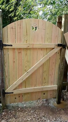 a wooden gate with an iron handle on it