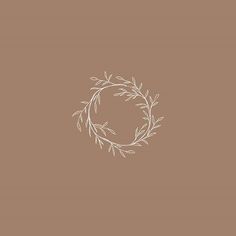 a white wreath on a brown background with the word love written in cursive writing