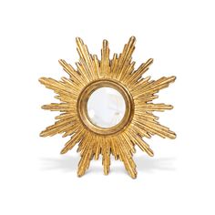 a gold sunburst shaped object with a mirror in the center on a white background