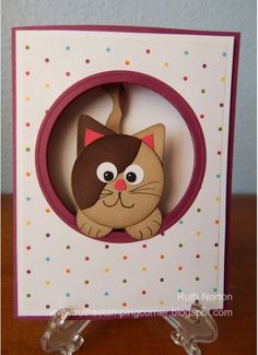 a close up of a card with a cat on it's face in a circle