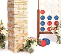 a wooden board game with flowers and vases next to it