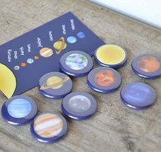 the solar system magnets have been placed next to each other on a wooden table