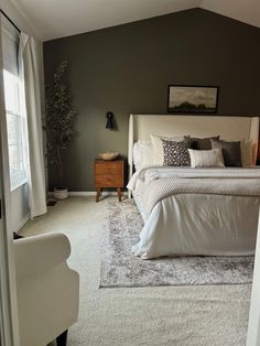 a bedroom with a bed, dresser and chair in it's centerpieces