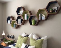 three hexagonal shelves on the wall above a bed