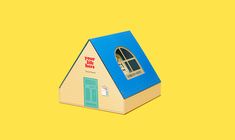 a house shaped like a book with a window and door on the roof that says, you're here