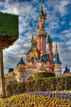 an image of a castle in the sky with flowers growing on it's sides