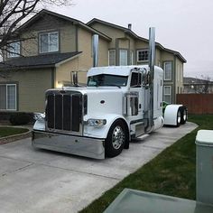 a large semi truck parked in front of a house