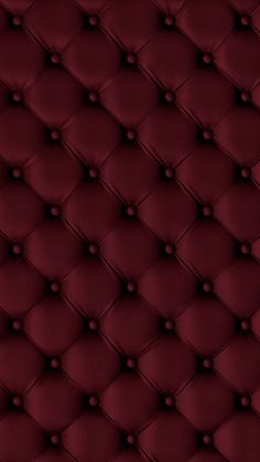 an upholstered red leather background