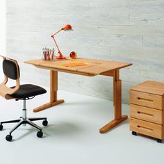 an office desk with a chair next to it